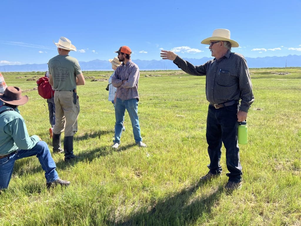 Rancher George Whitten points out interesting aspects of his field on the San Juan Ranch.