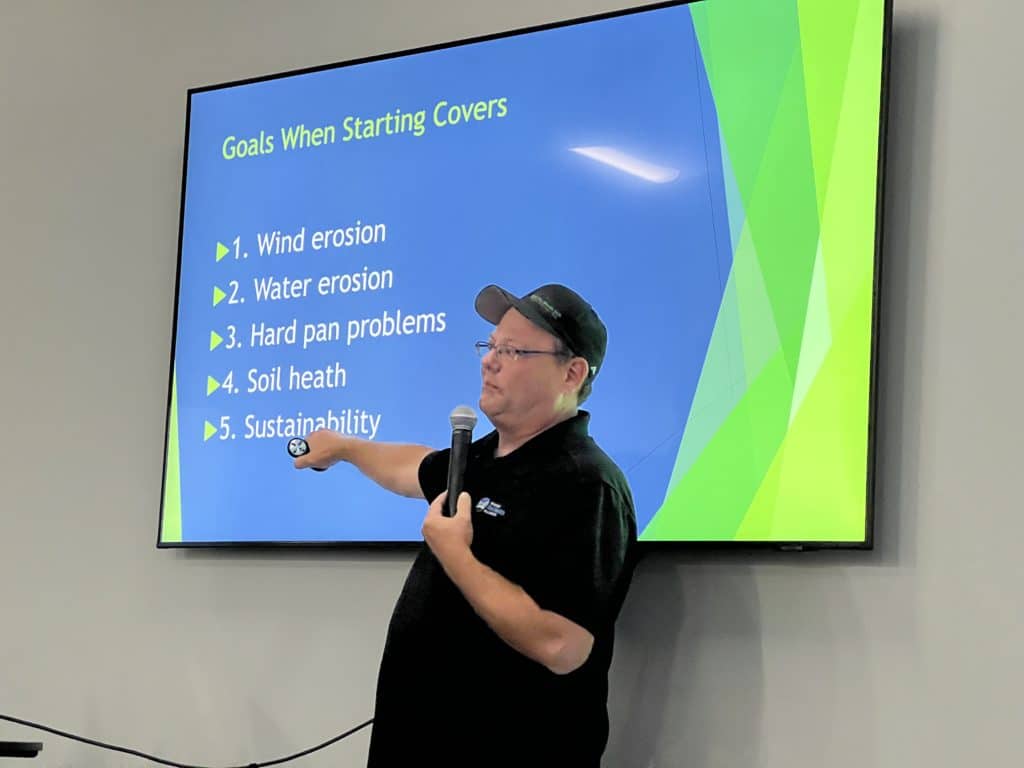 Kansas farmer Brice Custer points to a screen presentation about cover crops.